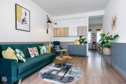 Emerald sofa in the interior of the kitchen living room