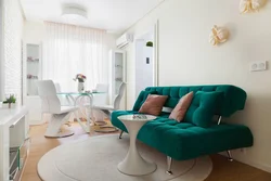 Emerald sofa in the interior of the kitchen living room