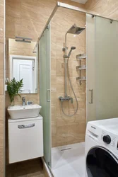 Bathroom interior with shower and toilet, washing machine