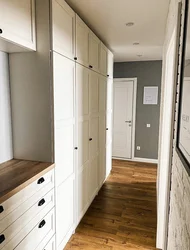 Design of a narrow hallway with a wardrobe in a modern style