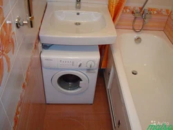 Design of a small bathroom with a sink above the washing machine