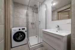 Bathroom in Khrushchev with a shower and washing machine photo