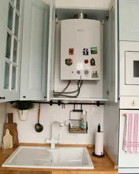 Gas boiler in the kitchen at home photo