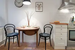 Round table in the interior of a small kitchen