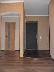 Tiles at the entrance door in the hallway and laminate photo