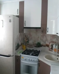 Kitchen design in Khrushchev with a gas water heater and a washing refrigerator