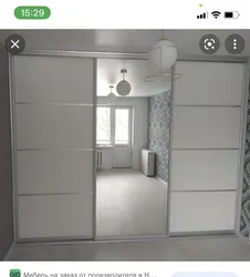 Photo of a wardrobe in the bedroom with a mirror for three doors