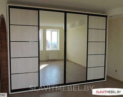 Photo of a wardrobe in the bedroom with a mirror for three doors
