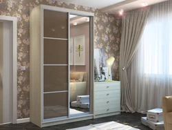 Photo of a wardrobe in the bedroom with a mirror for three doors