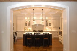 Kitchen with an arch to the living room in the apartment photo