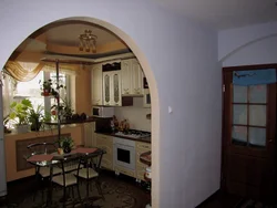 Kitchen With An Arch To The Living Room In The Apartment Photo
