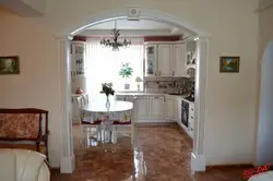 Kitchen with an arch to the living room in the apartment photo