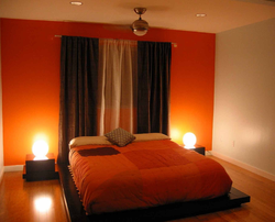 Orange wallpaper in the bedroom interior