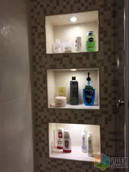 Niche in the bathroom for shampoos made of tiles photo