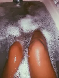 Photo of women's legs in the bathroom