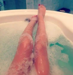 Photo of women's legs in the bathroom