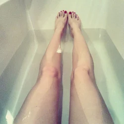 Photo of women's legs in the bathroom