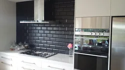 Kitchens With Black Tiles On The Wall Photo