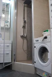 Bathroom design photo with shower, washing machine, toilet