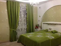 Green color of curtains in the bedroom interior