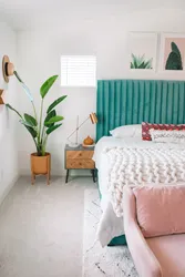 Turquoise bed in a bedroom interior with soft