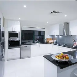 Photo of white kitchen and household