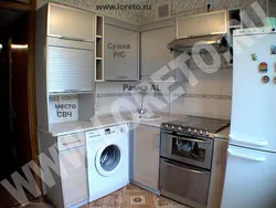 Kitchen with gas water heater and washing machine photo
