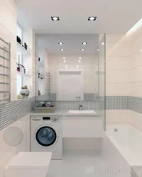 Interior of a bathroom with a bathtub without a toilet with a washing machine