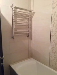 Heated towel rail photo in the bathroom in the apartment