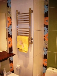 Heated towel rail photo in the bathroom in the apartment