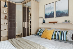 Wardrobes in a small bedroom design photo