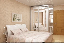 Wardrobes in a small bedroom design photo