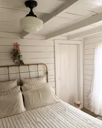 Interior of a bright bedroom in a wooden house