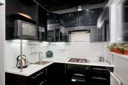 Corner black and white kitchens in the interior photo