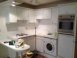 Corner kitchen with refrigerator and washing machine photo