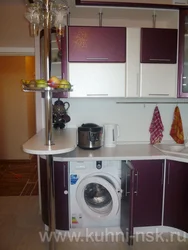 Corner kitchen with refrigerator and washing machine photo