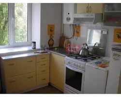 Kitchens in Khrushchev with a gas water heater and a refrigerator design