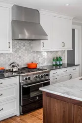 Kitchen with a gray countertop in a white interior and an apron