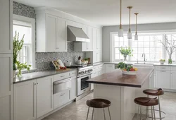 Kitchen with a gray countertop in a white interior and an apron