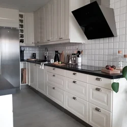 White kitchen design with black handles