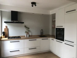 White kitchen design with black handles