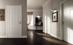 White doors and baseboards in the apartment interior photo