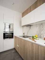 Combined white kitchen with wood photo