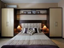 Wardrobes above the bed in the bedroom design