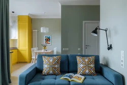 Yellow sofa in the interior of the kitchen living room