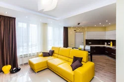 Yellow sofa in the interior of the kitchen living room
