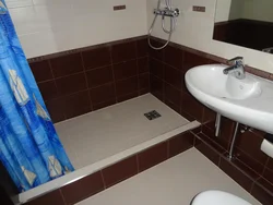 Photo of a bathroom with a tray instead of a bathtub