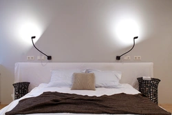 One lamp above the bed in the bedroom photo