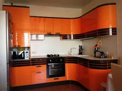 Orange-black kitchen in the interior photo