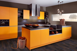 Orange-black kitchen in the interior photo